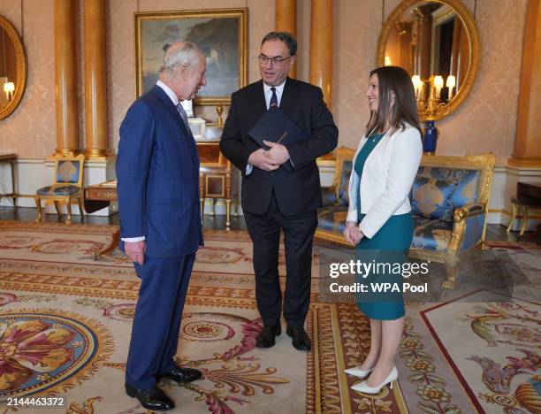 King Charles III is presented with the first bank notes featuring his portrait from the Bank of England Governor Andrew Bailey and Sarah John, the...