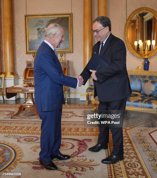 King Charles III is presented with the first bank notes featuring his portrait from the Bank of England Governor Andrew Bailey at Buckingham Palace,...