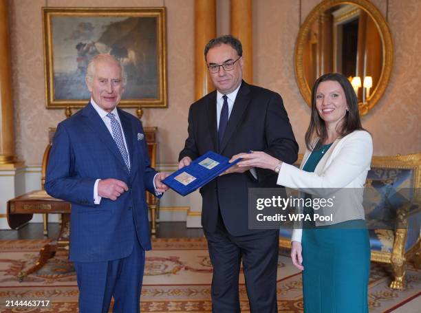 King Charles III is presented with the first bank notes featuring his portrait from the Bank of England Governor Andrew Bailey and Sarah John, the...