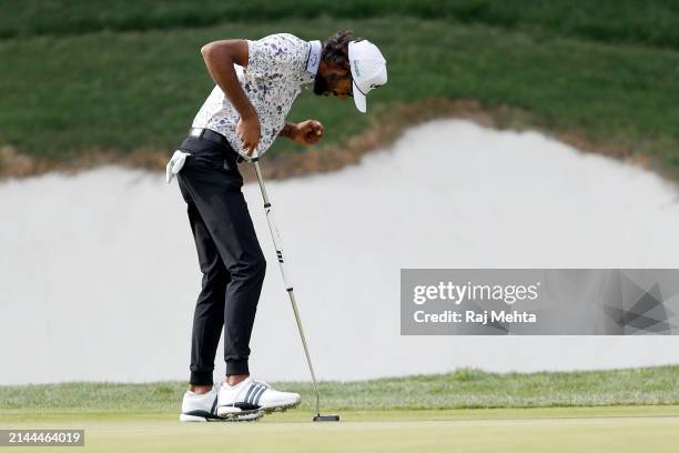 Akshay Bhatia of the United States celebrates after playing his put shot on the 18th hole during the third round of the Valero Texas Open at TPC San...