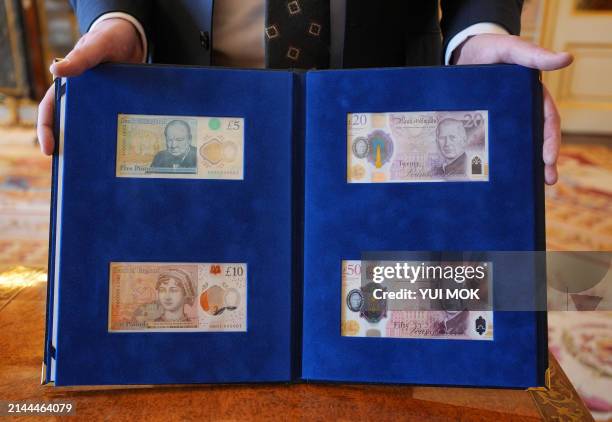 New bank notes that bear a portrait of King Charles III, and which will enter circulation on June 5 are displayed for a photograph after having been...