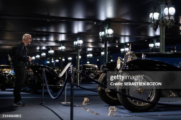 Man looks at a 1929 Bugatti Royale Coupe Type 41 during the press preview of the exhibition titled "De Monaco à Mulhouse: La collection du Prince...
