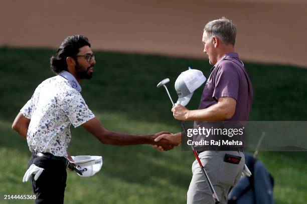 Akshay Bhatia of the United States chakes hands with Brendon Todd of the United States at the end of their round on the 18th hole during the third...