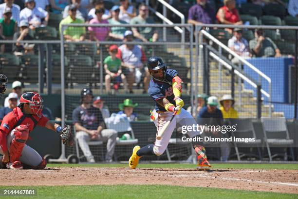 Ronald Acuña Jr. #13 of the Atlanta Braves hits a single during the sixth inning of a spring training game against the Boston Red Sox at CoolToday...