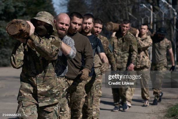 Young recruits undergo military training in the form of an obstacle course at the recruiting center in Kyiv. After completing the training, they all...