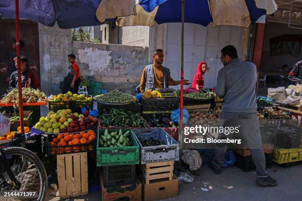 Palestinians shop for food at a street market in Deir al-Balah, central Gaza, on Tuesday, April 9, 2024. International pressure has intensified on...