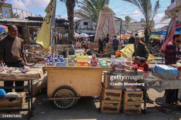 Palestinian vendors sell food and provisions at a street market in Deir al-Balah, central Gaza, on Tuesday, April 9, 2024. International pressure has...
