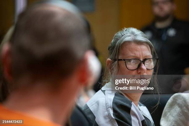 Jennifer Crumbley looks at her husband James Crumbley during their sentencing on four counts of involuntary manslaughter for the deaths of four...