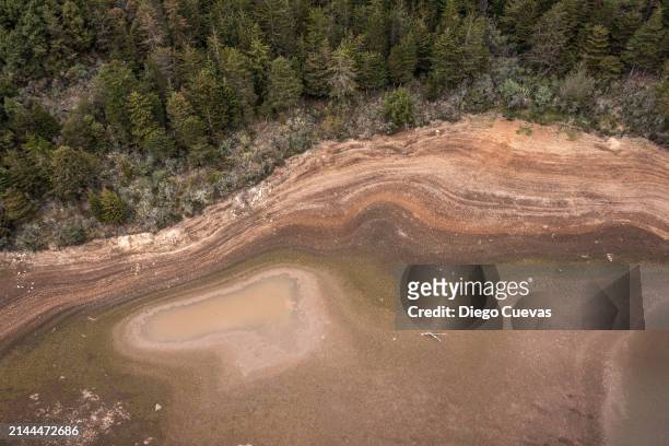 Aerial view of a now dry section of reservoir bed at Embalse La Regadera due to its historic low in the town of Usme on April 8, 2024 in Bogota,...