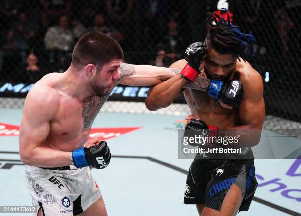Chepe Mariscal punches Morgan Charriere of France in a featherweight fight during the UFC Fight Night event at UFC APEX on April 06, 2024 in Las...