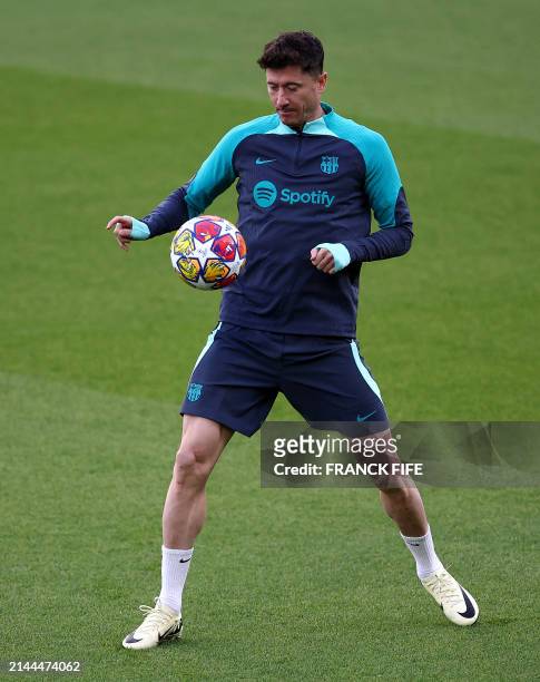 Barcelona's Polish forward Robert Lewandowski controls the ball during a training session at the Parc des Princes stadium in Paris, on April 9 on the...