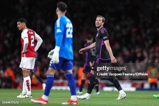 Harry Kane of Bayern Munich looks towards Arsenal goalkeeper David Raya with a smile after scoring their 2nd goal from the penalty spot during the...