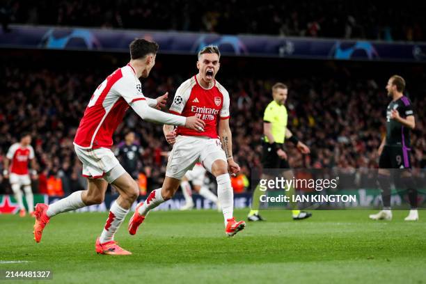 Arsenal's Belgian midfielder Leandro Trossard celebrates after scoring his team second goal during the UEFA Champions League quarter final first-leg...