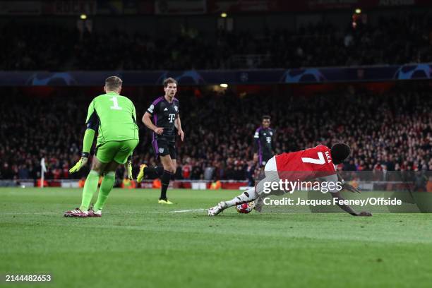 Bayern Munich goalkeeper Manuel Neuer fouls Bukayo Saka of Arsenal but no penalty is given during the UEFA Champions League quarter-final first leg...