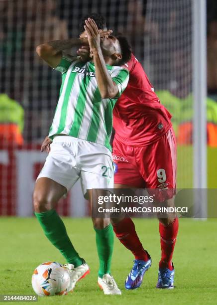 Racing's forward Jonathan Urretaviscaya and Argentinos Juniors' forward Maxi Romero fight for the ball during the Copa Sudamericana group stage first...