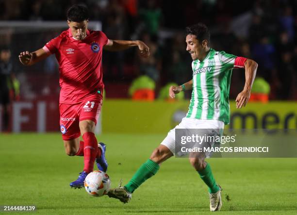 Argentinos Juniors' midfielder Nicolas Oroz and Racing's midfielder Jose Pablo Varela fight for the ball during the Copa Sudamericana group stage...