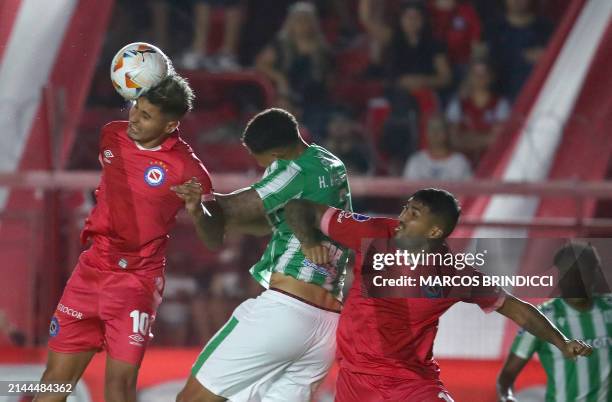 Racing's defender Hugo Magallanes fights for the ball with Argentinos Juniors' forward Gaston Veron and Argentinos Juniors' defender Francisco...