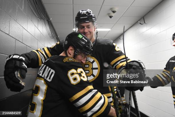 Brad Marchand and Brandon Carlo of the Boston Bruins hug before the game against the Carolina Hurricanes at the TD Garden on April 9, 2024 in Boston,...