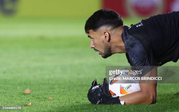 Racing's goalkeeper Renzo Bacchia grabs the ball during the Copa Sudamericana group stage first leg match between Argentina's Argentinos Juniors and...