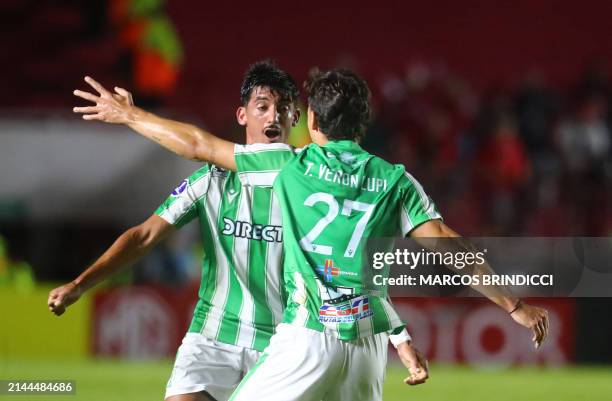 Racing's forward Tomas Veron celebrates with Racing's midfielder Lucas Rodriguez after scoring during the Copa Sudamericana group stage first leg...