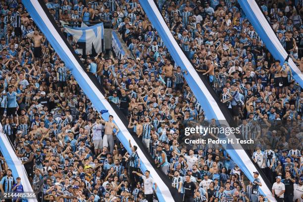 Fans of Gremio cheer for their team during the Copa CONMEBOL Libertadores 2024 group C match between Gremio and Huachipato at Arena do Gremio on...