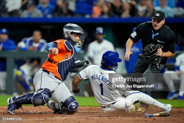 Melendez of the Kansas City Royals is tagged out at home plate by Yainer Diaz of the Houston Astros during the sixth inning at Kauffman Stadium on...