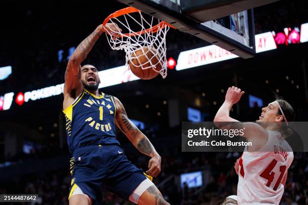 Obi Toppin of the Indiana Pacers dunks against Kelly Olynyk of the Toronto Raptors during the second half of their NBA game at Scotiabank Arena on...