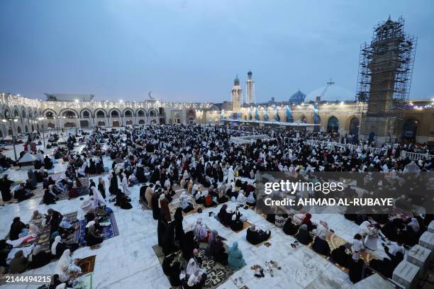 Worshippers pray on the first day of Eid al-Fitr, which marks the end of the holy fasting month of Ramadan, at the Sunni Muslim mosque of Abdul Qader...