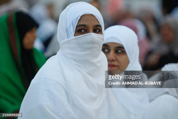 Women attend the morning prayer on the first day of Eid al-Fitr, which marks the end of the holy fasting month of Ramadan, at the Sunni Muslim mosque...