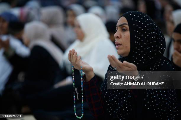 Women pray on the first day of Eid al-Fitr, which marks the end of the holy fasting month of Ramadan, at the Sunni Muslim mosque of Abdul Qader...