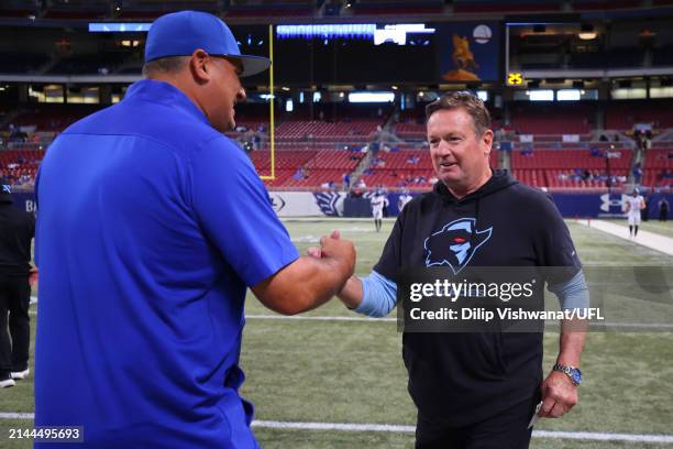 St. Louis Battlehawks head coach Anthony Becht and Arlington Renegades head coach Bob Stoops speak before a game at The Dome at America’s Center on...