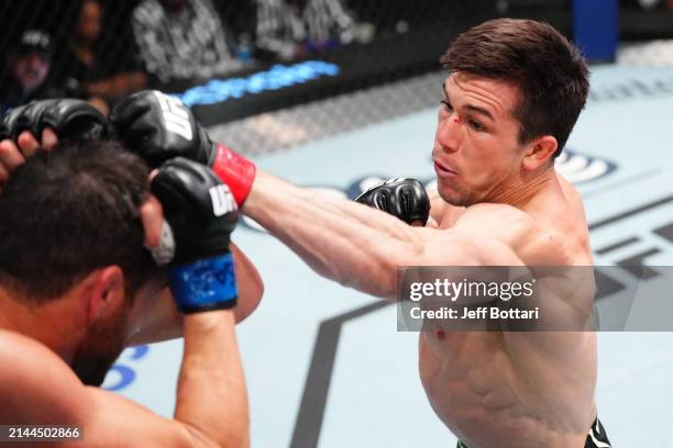 Alexander Hernandez punches Damon Jackson in a featherweight fight during the UFC Fight Night event at UFC APEX on April 06, 2024 in Las Vegas,...