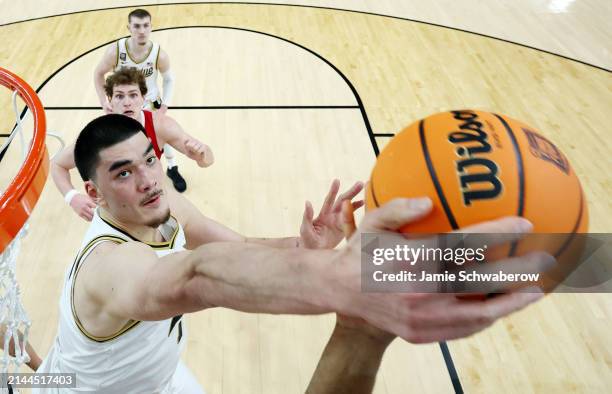 Zach Edey of the Purdue Boilermakers blocks the ball against Casey Morsell of the North Carolina State Wolfpack during the second half in the NCAA...