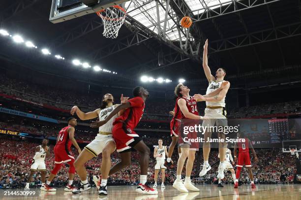 Zach Edey of the Purdue Boilermakers attempts a shot while being guarded by Ben Middlebrooks of the North Carolina State Wolfpack in the second half...