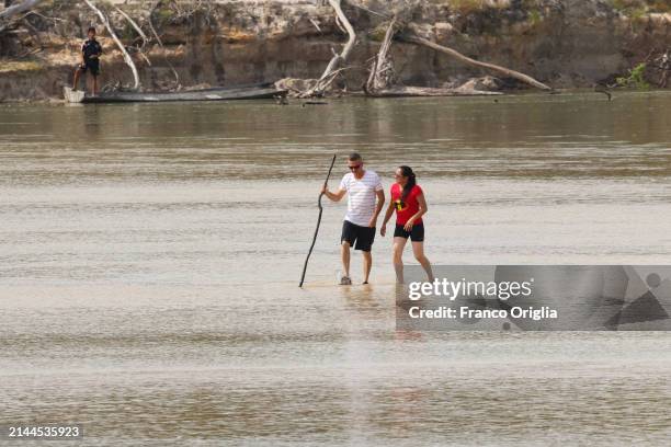 Couple takes a walk on the Bita river on April 06, 2024 in Puerto Carreño, Colombia. Puerto Carreño is the departmental capital city, and a...