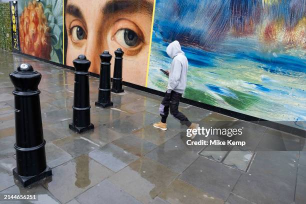 National Gallery celebrates its 200th year a hoarding featuring details from many well known paintings by famous artists including the painting...