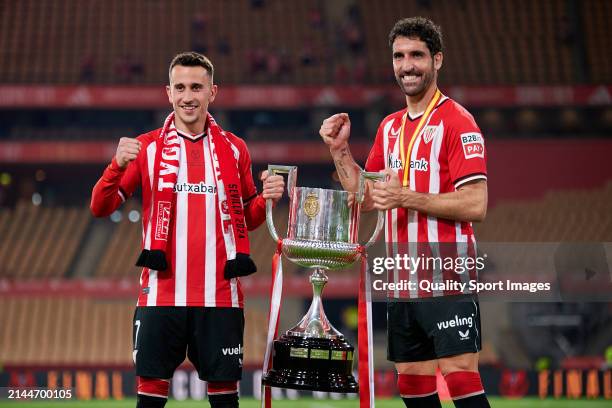 Alex Berenguer and Raul Garcia of Athletic Club pose with the Copa Del Rey trophy following his sides victory in the Copa Del Rey Final match between...