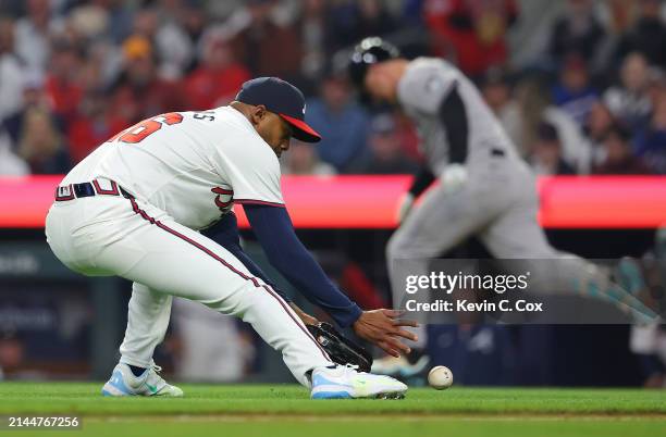 Raisel Iglesias of the Atlanta Braves makes a play on a bunt by Joc Pederson of the Arizona Diamondbacks in the ninth inning at Truist Park on April...