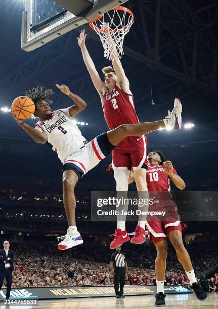 Tristen Newton of the Connecticut Huskies attempts to lay up around Grant Nelson of the Alabama Crimson Tide during the second half in the NCAA Men’s...