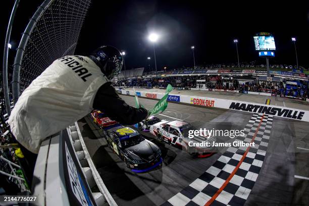 Aric Almirola, driver of the He Gets Us Toyota, and Sam Mayer, driver of the 10X Health Chevrolet, lead the field to the restart during the NASCAR...