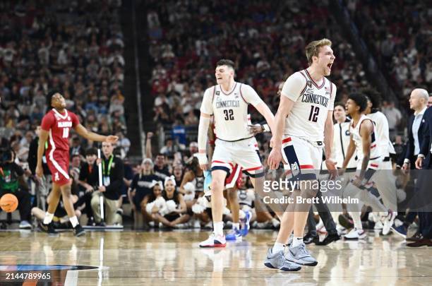 Cam Spencer of the Connecticut Huskies celebrates during the second half in the NCAA Men’s Basketball Tournament Final Four semifinal game against...