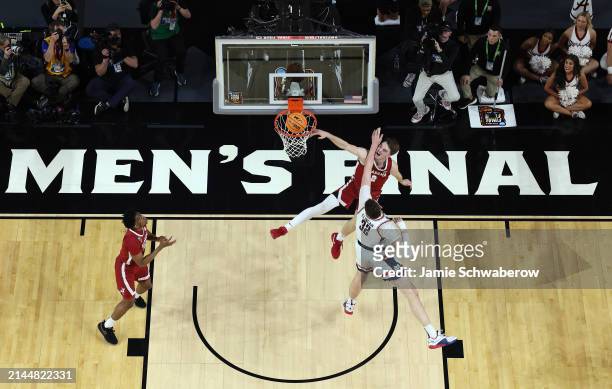 Grant Nelson of the Alabama Crimson Tide lay up against Donovan Clingan of the Connecticut Huskies during the second half in the NCAA Men’s...