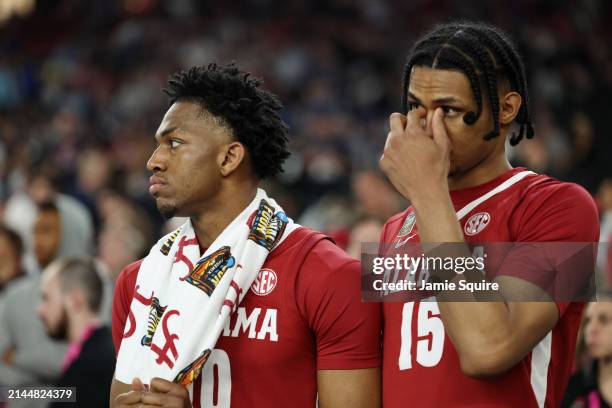 Mouhamed Dioubate and Jarin Stevenson of the Alabama Crimson Tide look on from the bench in the second half against the Connecticut Huskies in the...
