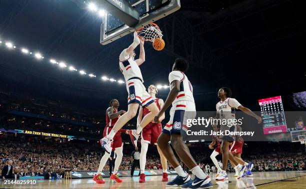 Donovan Clingan of the Connecticut Huskies dunks during the second half in the NCAA Men’s Basketball Tournament Final Four semifinal game against the...