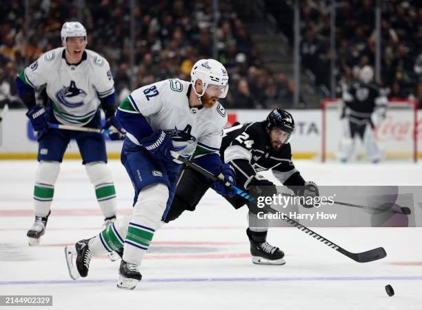 Ian Cole of the Vancouver Canucks skates away from Phillip Danault of the Los Angeles Kings during the second period at Crypto.com Arena on April 06,...