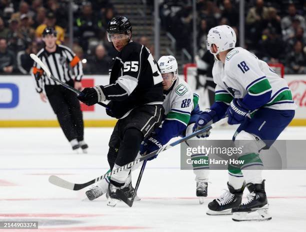 Quinton Byfield of the Los Angeles Kings shoots the puck in front of Nils Aman ad Sam Lafferty of the Vancouver Canucks during the second period at...