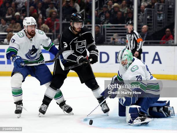 Casey DeSmith of the Vancouver Canucks makes a save on Matt Roy of the Los Angeles Kings as Filip Hronek skates for the rebound during the second...