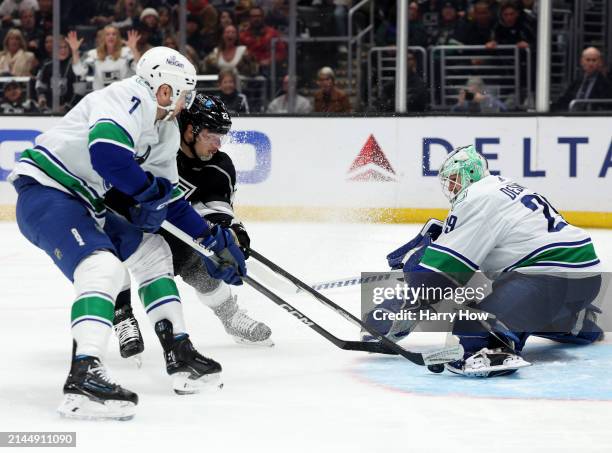 Kevin Fiala of the Los Angeles Kings scores a goal between Casey DeSmith and Carson Soucy of the Vancouver Canucks, to take a 4-1 lead, during the...