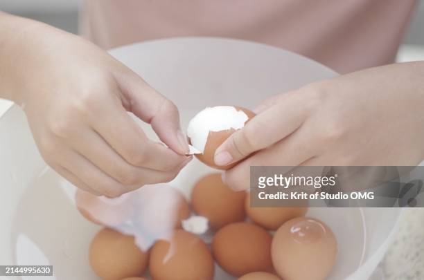 close-up view a girl peeling the boiled egg - cooked eggs stock pictures, royalty-free photos & images