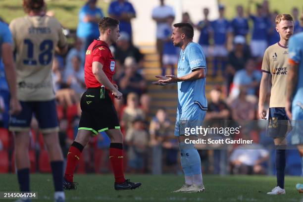 Referee Jack Morgan gives Róbert Mak of Sydney FC a red card during the A-League Men round 23 match between Newcastle Jets and Sydney FC at McDonald...
